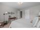 Cozy bedroom showcasing a wood desk, decorative wall art, and a comfortable bed with stylish pillows at 2812 Lemnos Dr, Apex, NC 27502