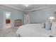 Comfortable bedroom with blue accents, ensuite bathroom, and soft lighting at 2812 Lemnos Dr, Apex, NC 27502
