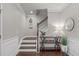 Foyer with hardwood floors, staircase with white risers, and decorative console table at 2812 Lemnos Dr, Apex, NC 27502