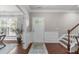 Inviting foyer with hardwood floors, elegant wainscoting, and a bright entrance with a glass paneled door at 2812 Lemnos Dr, Apex, NC 27502