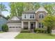 Charming two-story home featuring a brick facade, covered porch, well-maintained landscaping and an attached two car garage at 2812 Lemnos Dr, Apex, NC 27502