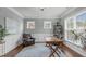 Bright home office with large windows, wood floors, classic wainscoting and a decorative rug at 2812 Lemnos Dr, Apex, NC 27502