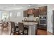 Kitchen featuring granite countertops, dark wood cabinets, and stainless steel appliances at 2812 Lemnos Dr, Apex, NC 27502