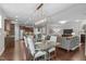 Open floor plan between kitchen, dining, and living room shows neutral walls, hardwood floors, and modern furniture at 2812 Lemnos Dr, Apex, NC 27502