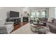 Comfortable living room features hardwood floors, a fireplace with mantle, neutral walls, modern furnishings at 2812 Lemnos Dr, Apex, NC 27502