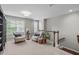 Relaxing living space with seating, decorative plants, and natural light from large windows at 2812 Lemnos Dr, Apex, NC 27502