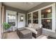 Relaxing screened porch featuring wicker furniture, a ceiling fan, and views of the landscaped yard at 2812 Lemnos Dr, Apex, NC 27502
