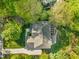 Overhead aerial view of a home with lush surroundings showcasing the roof, deck and driveway at 314 Hogan Woods Cir, Chapel Hill, NC 27516