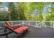 Spacious deck area with lounge seating, offering a serene view of the lush, wooded backyard at 314 Hogan Woods Cir, Chapel Hill, NC 27516
