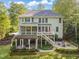 Expansive backyard featuring a spacious deck, outdoor kitchen, stone patio with firepit, and lush landscaping at 314 Hogan Woods Cir, Chapel Hill, NC 27516