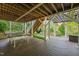Covered backyard patio features a ping pong table, seating and a hammock at 314 Hogan Woods Cir, Chapel Hill, NC 27516