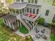 Aerial view of the backyard, showcasing the deck, firepit area, screened-in porch, and lush green lawn at 314 Hogan Woods Cir, Chapel Hill, NC 27516