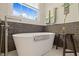 Modern bathtub with stylish fixtures next to a window and gray subway tile at 314 Hogan Woods Cir, Chapel Hill, NC 27516