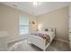 Bright bedroom featuring a single bed, soft carpet and neutral colored walls at 314 Hogan Woods Cir, Chapel Hill, NC 27516