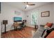 Bright bedroom with a desk, sofa, hardwood floors, a ceiling fan, and a window at 314 Hogan Woods Cir, Chapel Hill, NC 27516