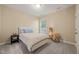 Cozy bedroom with a soft carpet, neutral walls, and natural light from the window at 314 Hogan Woods Cir, Chapel Hill, NC 27516