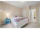 A bright bedroom featuring a comfortable bed, neutral decor, and access to an ensuite at 314 Hogan Woods Cir, Chapel Hill, NC 27516