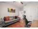 Bright bedroom with hardwood floors, a sofa, and white closet doors at 314 Hogan Woods Cir, Chapel Hill, NC 27516