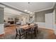 Elegant dining room with hardwood floors, decorative rug, and natural light flowing into the adjacent living room at 314 Hogan Woods Cir, Chapel Hill, NC 27516