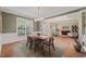 Bright dining room featuring large windows, a modern chandelier, and hardwood flooring at 314 Hogan Woods Cir, Chapel Hill, NC 27516