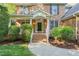 Inviting brick home entrance with white railings, arched entry, and landscaped surroundings at 314 Hogan Woods Cir, Chapel Hill, NC 27516