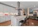 Open kitchen design with sleek white cabinets, marble countertops, and stainless steel appliances at 314 Hogan Woods Cir, Chapel Hill, NC 27516