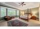 Elegant bedroom boasts tray ceilings, a cozy seating area, and an abundance of natural light at 314 Hogan Woods Cir, Chapel Hill, NC 27516