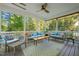 Relaxing screened porch with comfortable seating, ceiling fan, and views of lush greenery at 314 Hogan Woods Cir, Chapel Hill, NC 27516