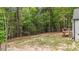View of the wood deck with stairs, backyard, and surrounding lush trees, creating a private outdoor setting at 318 Natchez Trace, Fuquay Varina, NC 27526