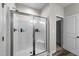 Bathroom with a glass-enclosed shower and bench, and a neutral color palette at 318 Natchez Trace, Fuquay Varina, NC 27526