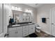 Bathroom features a double sink vanity with a dark countertop and modern fixtures at 318 Natchez Trace, Fuquay Varina, NC 27526