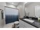Bathroom features a sink, toilet, patterned shower curtain, and modern fixtures at 318 Natchez Trace, Fuquay Varina, NC 27526