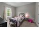 Bedroom featuring a black metal bedframe, carpeted floor, and natural light from the window at 318 Natchez Trace, Fuquay Varina, NC 27526