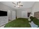 Well-lit bedroom with an olive comforter, fan, and an entertainment center with drawers at 318 Natchez Trace, Fuquay Varina, NC 27526