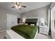 Comfortable bedroom featuring a stylish bed with a tufted headboard and a relaxing green comforter at 318 Natchez Trace, Fuquay Varina, NC 27526