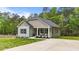 Charming single-story home with a well-manicured lawn, cozy front porch and extended driveway at 318 Natchez Trace, Fuquay Varina, NC 27526