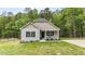Charming home showcasing light siding, a cozy front porch, a paved driveway, and landscaped features at 318 Natchez Trace, Fuquay Varina, NC 27526