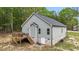 Exterior view of the home featuring a wooden deck with stairs and a door to the basement at 318 Natchez Trace, Fuquay Varina, NC 27526