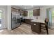 Modern kitchen featuring stainless steel appliances, granite countertops, and ample cabinet space at 318 Natchez Trace, Fuquay Varina, NC 27526