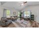 Bright and airy living room featuring vaulted ceilings, modern furniture, and large windows at 318 Natchez Trace, Fuquay Varina, NC 27526