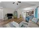 Open-concept living area with hardwood floors, modern decor, and seamless flow to the kitchen at 318 Natchez Trace, Fuquay Varina, NC 27526