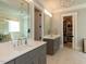 Elegant bathroom with double sink vanity, walk-in closet, and soaking tub with marble at 3416 Edgemont Dr, Raleigh, NC 27612