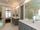 Double sink vanity bathroom, walk in shower and views into bedroom at 3416 Edgemont Dr, Raleigh, NC 27612