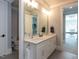 Bright bathroom features a double vanity and access to a bedroom and office at 3416 Edgemont Dr, Raleigh, NC 27612