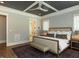 Bedroom with trey ceiling, fan, and a view into bathroom at 3416 Edgemont Dr, Raleigh, NC 27612