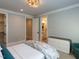 Neutral bedroom featuring a gray color scheme, modern lighting, and doorway to the bathroom at 3416 Edgemont Dr, Raleigh, NC 27612