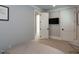 Comfortable bedroom featuring a mounted TV and neutral color scheme at 3416 Edgemont Dr, Raleigh, NC 27612