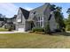 Elegant gray home boasts a manicured lawn and sophisticated architectural design, enhancing curb appeal at 3416 Edgemont Dr, Raleigh, NC 27612