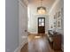 Stylish foyer with hardwood floors, a dark wood door and sophisticated light fixture at 3416 Edgemont Dr, Raleigh, NC 27612