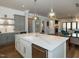 Modern kitchen showcasing a spacious island, quartz countertops, and stainless steel appliances at 3416 Edgemont Dr, Raleigh, NC 27612